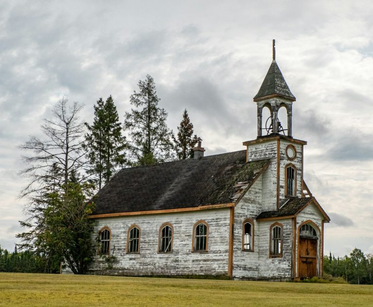 an old church with a steeple and a bell tower